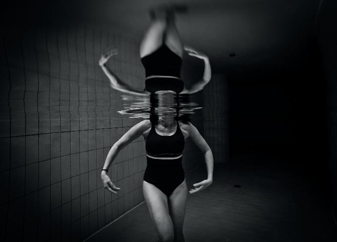 grayscale photo of woman wearing monokini on body of water